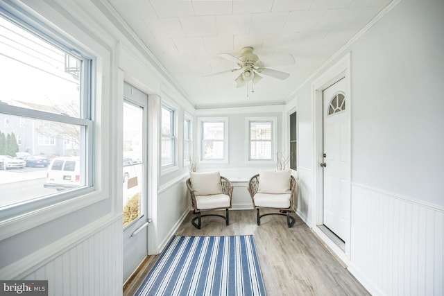 sunroom / solarium featuring ceiling fan