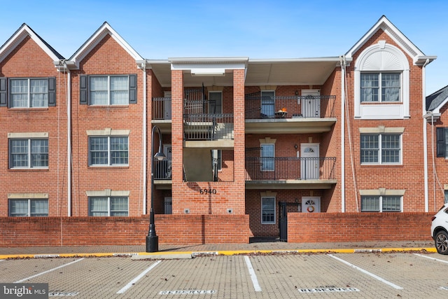 view of building exterior with uncovered parking