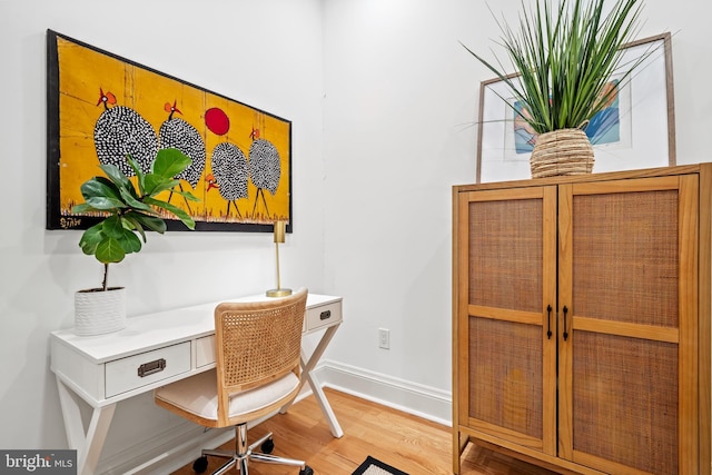 office featuring baseboards and wood finished floors