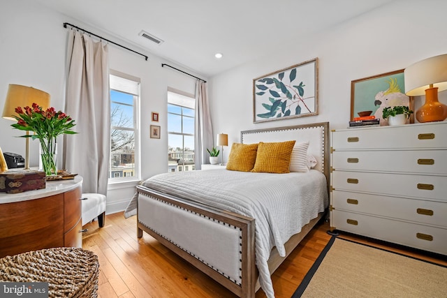 bedroom with light wood-type flooring, visible vents, and recessed lighting