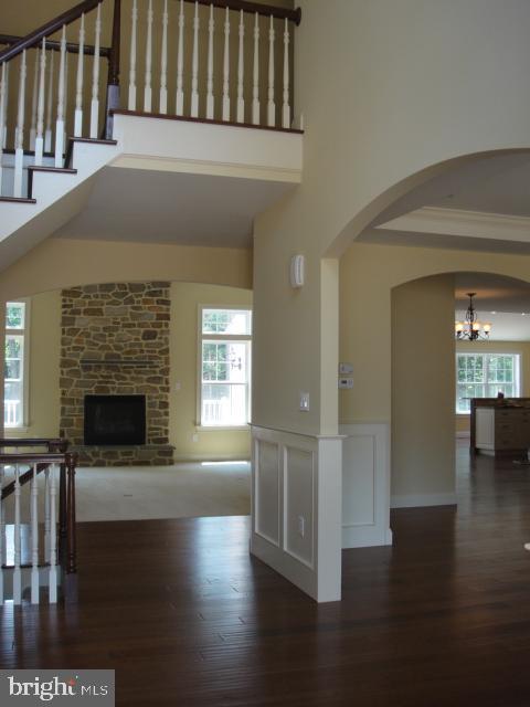 interior space featuring a brick fireplace, a healthy amount of sunlight, and dark hardwood / wood-style floors