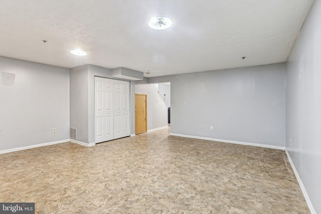 finished basement featuring visible vents and baseboards