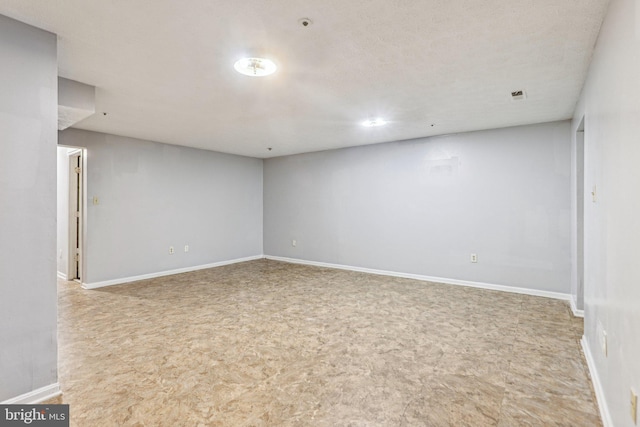 empty room featuring visible vents and baseboards