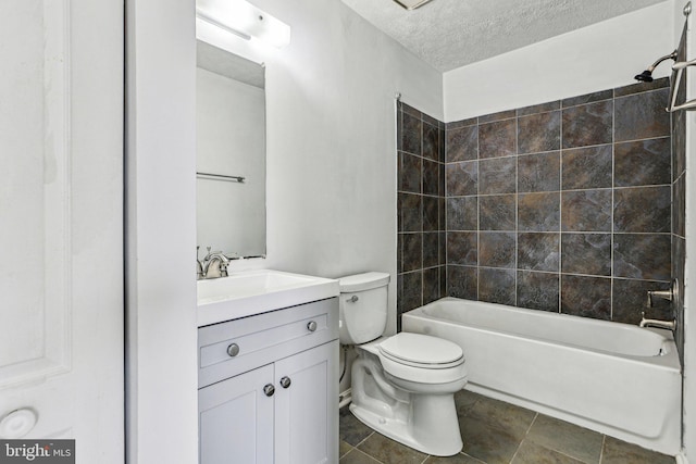 bathroom featuring bathtub / shower combination, toilet, a textured ceiling, vanity, and tile patterned flooring