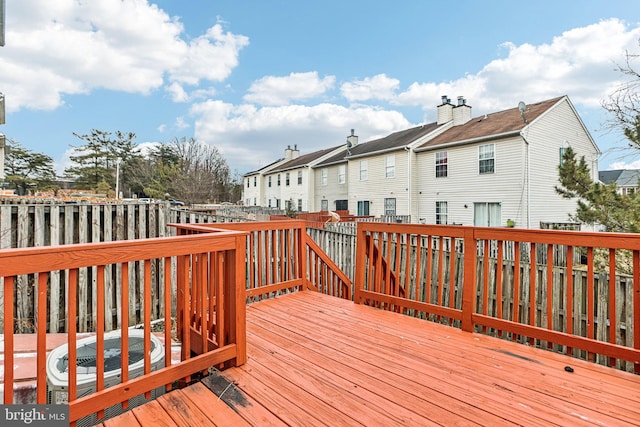 wooden terrace featuring central AC unit and a residential view