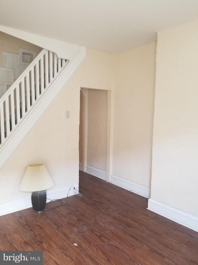 interior space featuring baseboards and wood finished floors