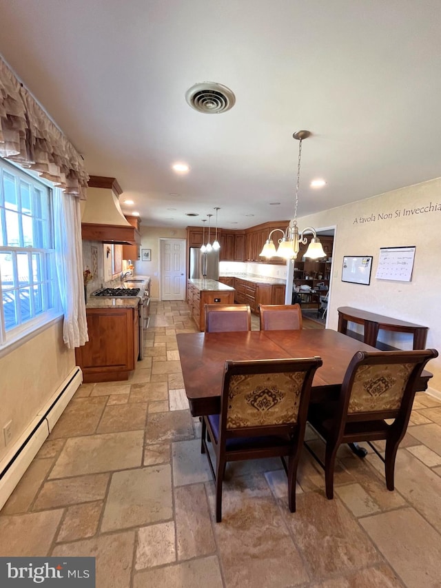 dining space featuring a notable chandelier, recessed lighting, stone tile floors, visible vents, and baseboard heating