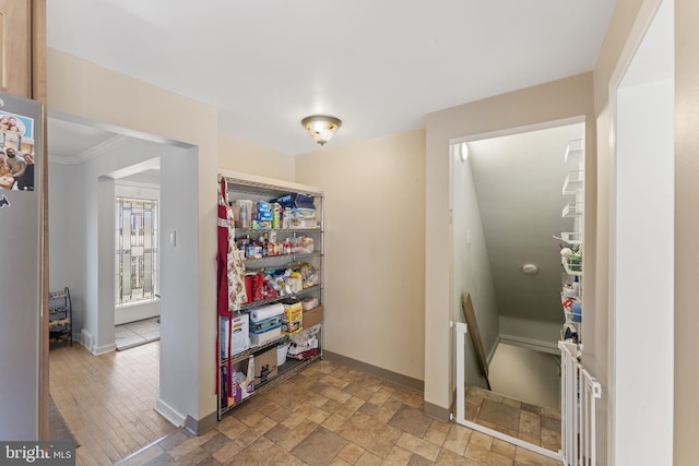 interior space with baseboards and stone tile floors