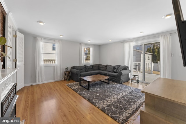 living room featuring light wood-style flooring and a wealth of natural light