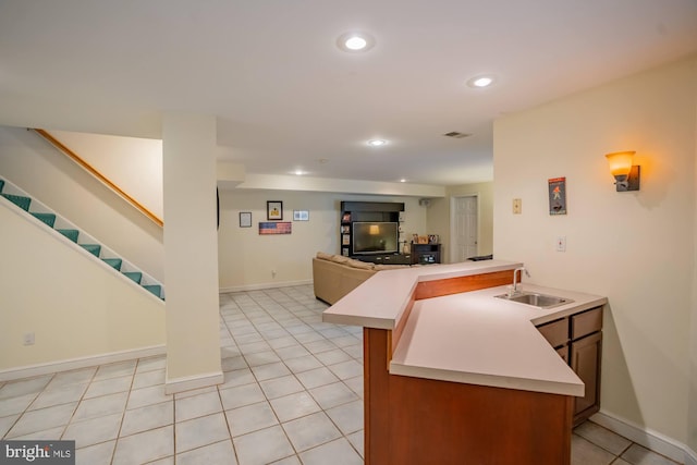 kitchen featuring a sink, open floor plan, recessed lighting, light tile patterned flooring, and light countertops