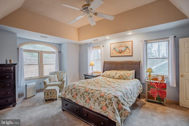 bedroom with visible vents, baseboards, light colored carpet, ceiling fan, and vaulted ceiling