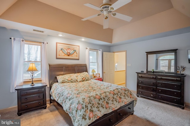 bedroom with visible vents, baseboards, carpet flooring, a raised ceiling, and vaulted ceiling