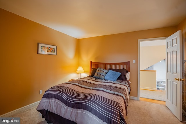 bedroom featuring baseboards and carpet