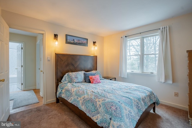 bedroom with baseboards and carpet