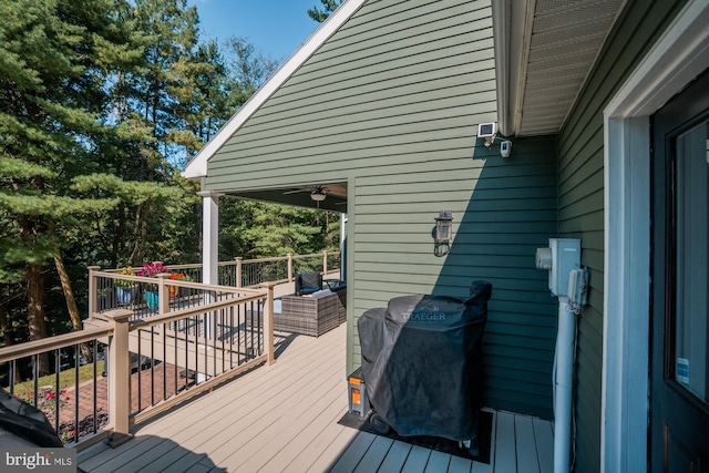 deck featuring area for grilling and a ceiling fan