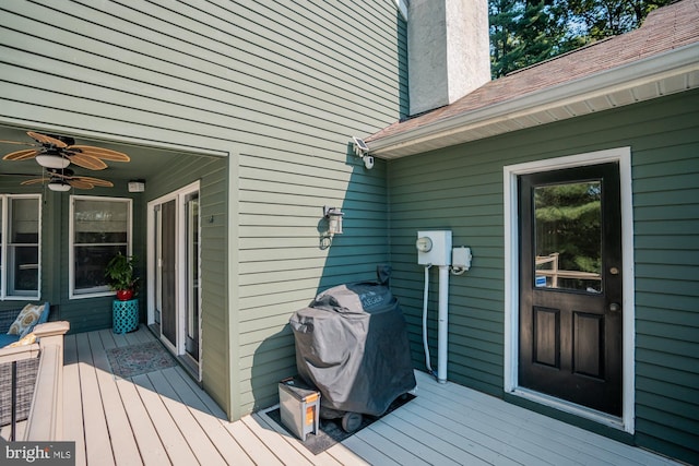 wooden terrace with a grill and ceiling fan