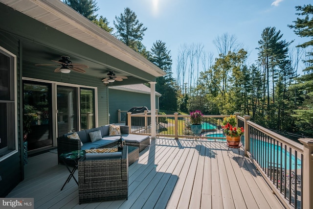 deck featuring a ceiling fan and an outdoor pool