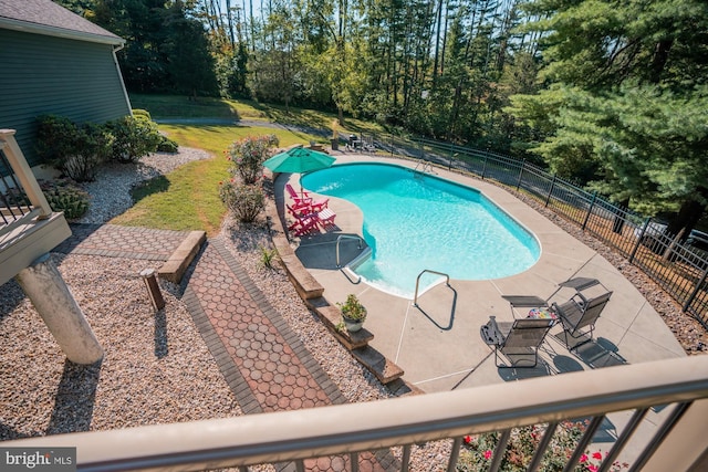 view of pool with a fenced in pool, a lawn, a patio, and fence