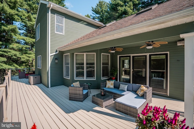 wooden terrace with an outdoor hangout area and a ceiling fan