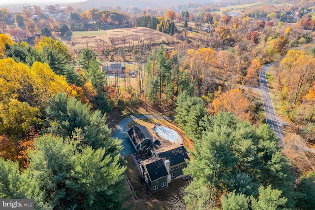 bird's eye view featuring a wooded view