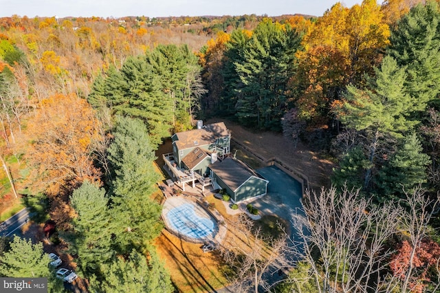 birds eye view of property featuring a view of trees