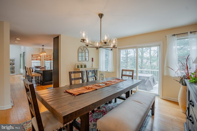 dining room featuring light wood-style floors and a chandelier