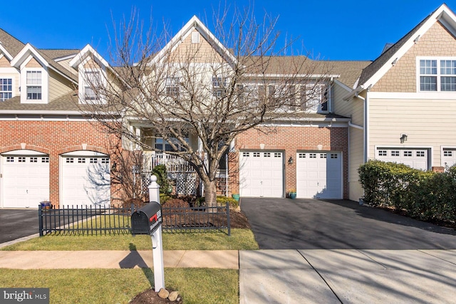 view of front of home with driveway, a front yard, and brick siding