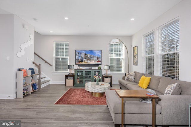 living area featuring recessed lighting, stairway, baseboards, and wood finished floors