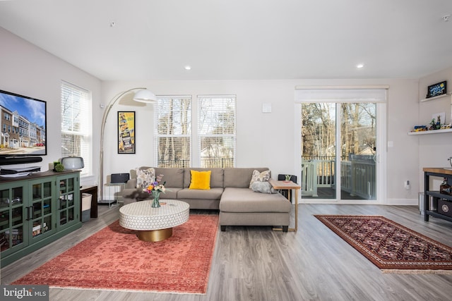 living area featuring recessed lighting, baseboards, and wood finished floors