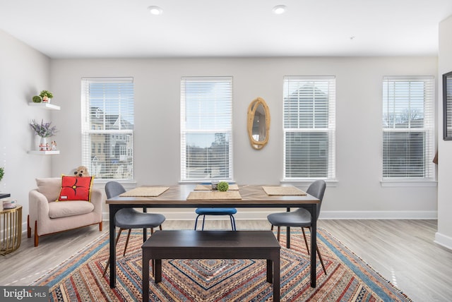 dining room featuring baseboards and light wood-style floors