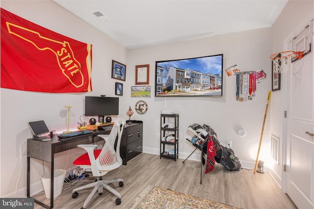 office with visible vents, light wood-style flooring, and baseboards