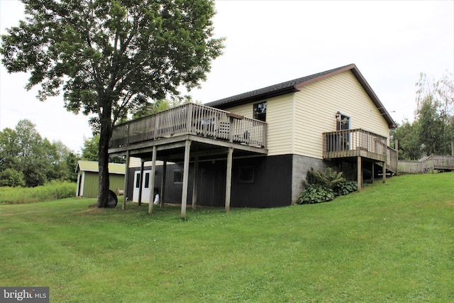 rear view of property featuring a yard and a wooden deck