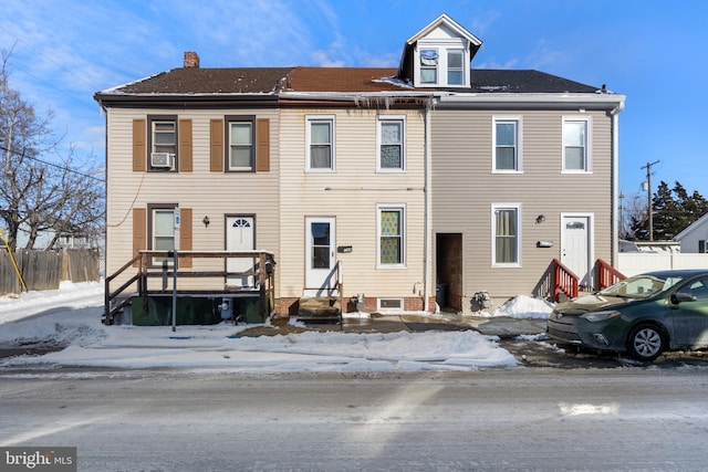 view of front of house featuring entry steps, cooling unit, and fence