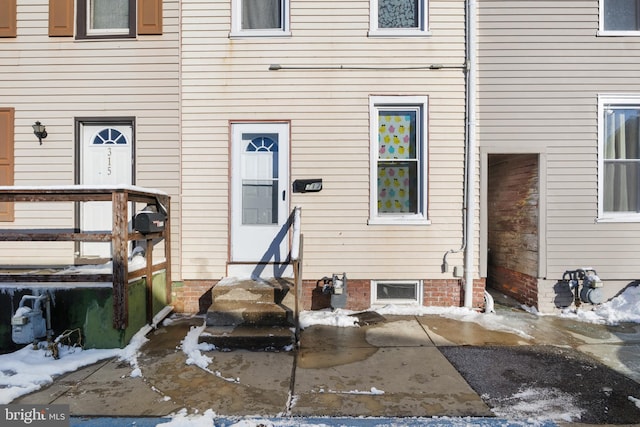 view of snow covered property entrance