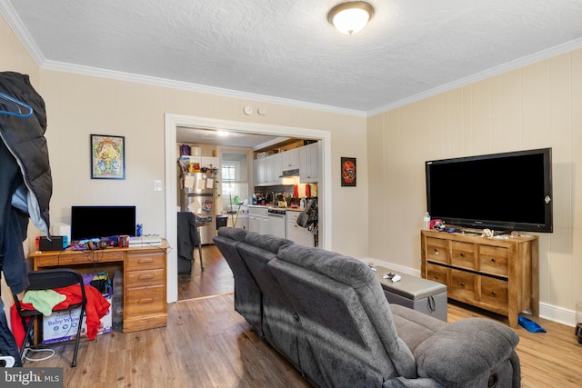 living area featuring a textured ceiling, ornamental molding, and wood finished floors