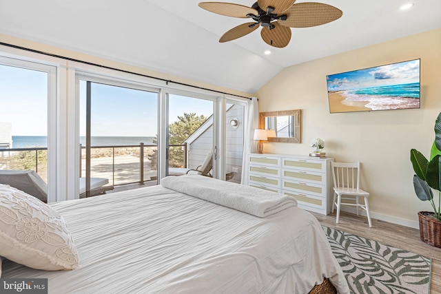 bedroom featuring access to exterior, recessed lighting, a water view, vaulted ceiling, and wood finished floors