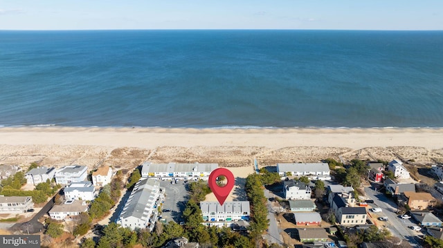 aerial view featuring a water view and a beach view