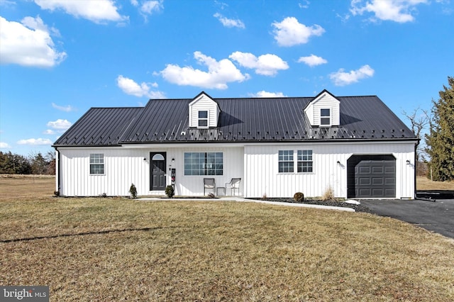 modern farmhouse featuring a garage and a front lawn