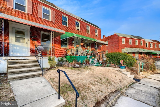 view of property featuring brick siding