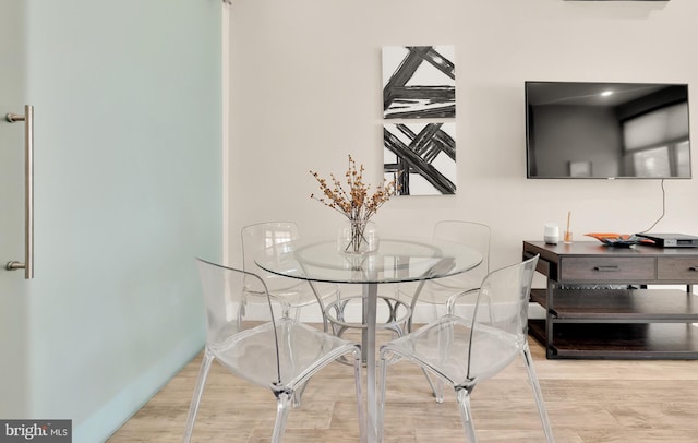 dining area with hardwood / wood-style floors