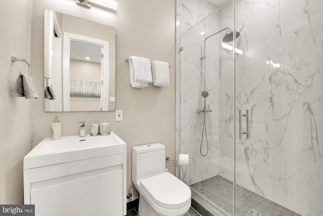 bathroom with toilet, a shower with door, and vanity