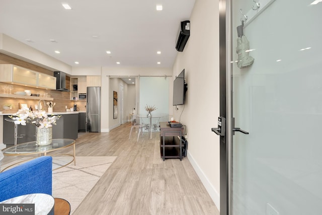 interior space featuring light hardwood / wood-style floors and a barn door