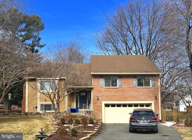 view of front facade with a garage, brick siding, and driveway