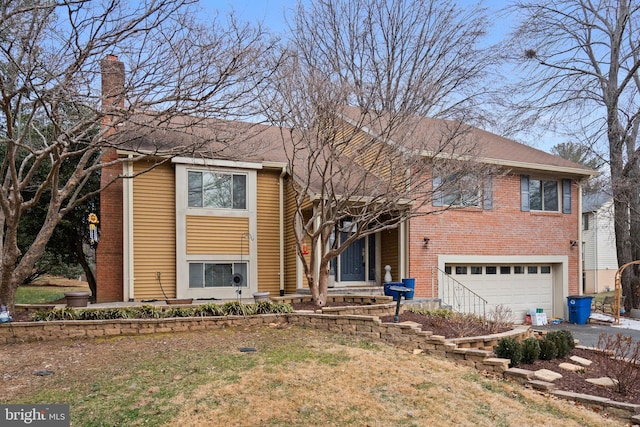 bi-level home featuring brick siding, driveway, a chimney, and an attached garage