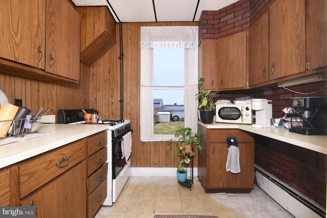 15 N 10th St, Lebanon, PA 17046 - kitchen featuring white appliances, a baseboard heating unit, light countertops, and brown cabinetry