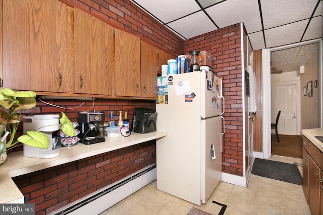 15 N 10th St, Lebanon, PA 17046 - kitchen with a drop ceiling, light countertops, baseboard heating, freestanding refrigerator, and brown cabinets