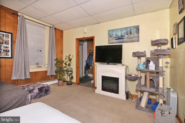 15 N 10th St, Lebanon, PA 17046 - carpeted living room featuring a fireplace, a paneled ceiling, and baseboards