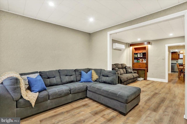 living room with recessed lighting, a wall mounted air conditioner, wood finished floors, and baseboards