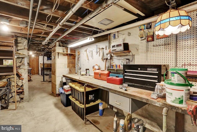 unfinished basement with a workshop area