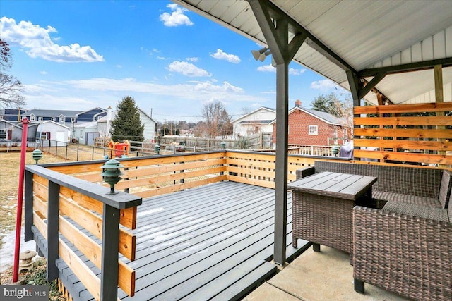 wooden terrace with a residential view and fence